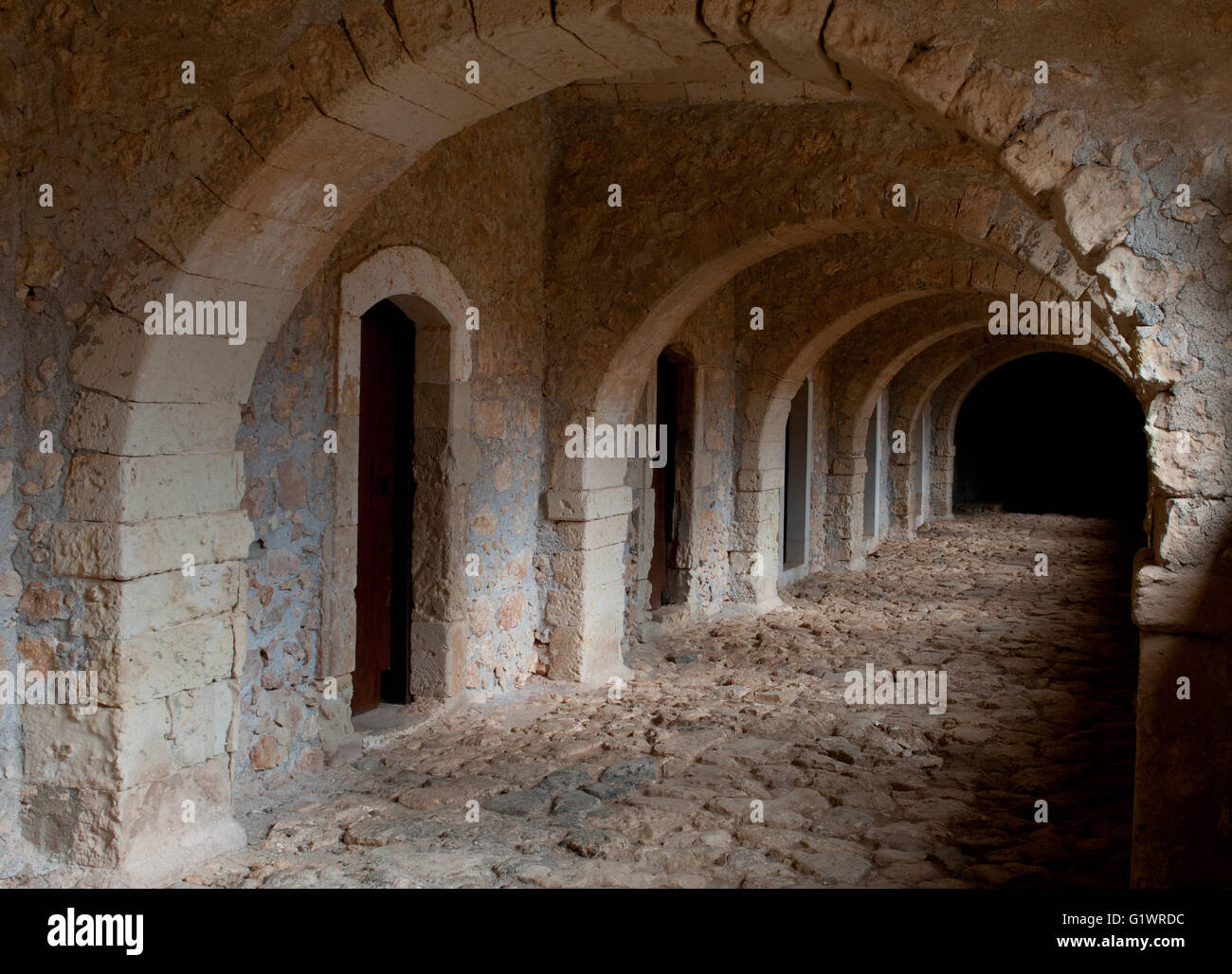 Ancient passage leading to priest rooms in the Famous Arkadi Christian orthodox monastery in Crete, Greece Stock Photo