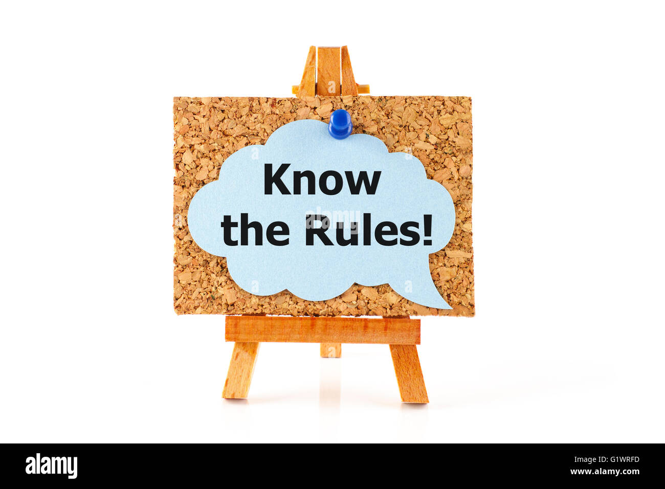 Wooden easel with cork board and blue speech bubble with words Know the Rules! on white background Stock Photo