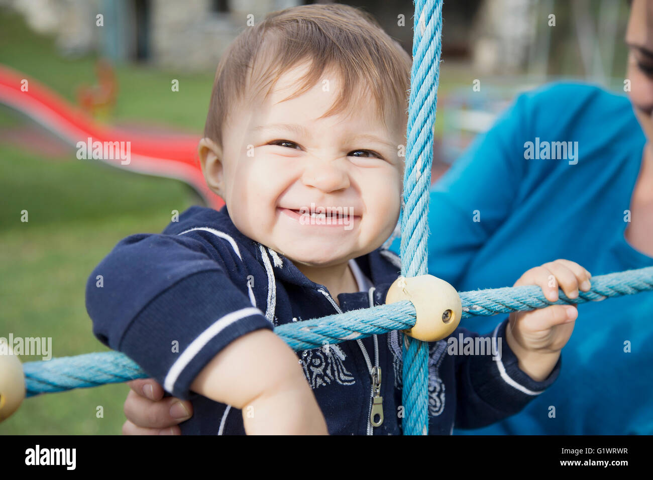 One year old baby girl smiling and looking at camera Stock Photo