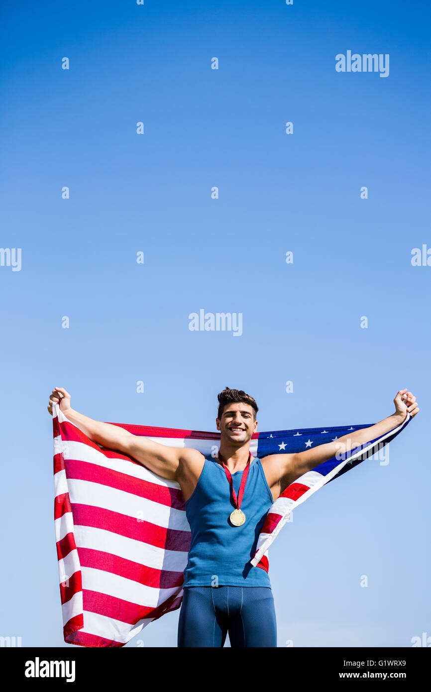 Athlete posing with american flag and gold medals around his neck Stock ...