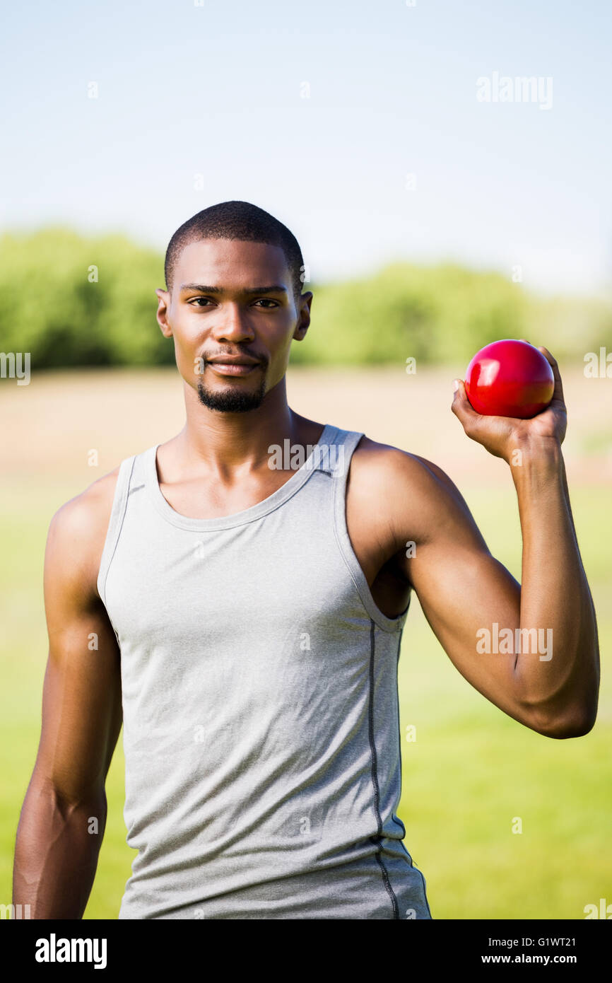Male athlete holding shot put ball Stock Photo Alamy