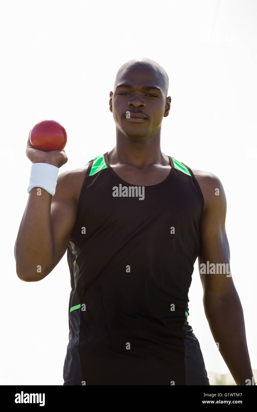 Male athlete holding shot put ball Stock Photo Alamy