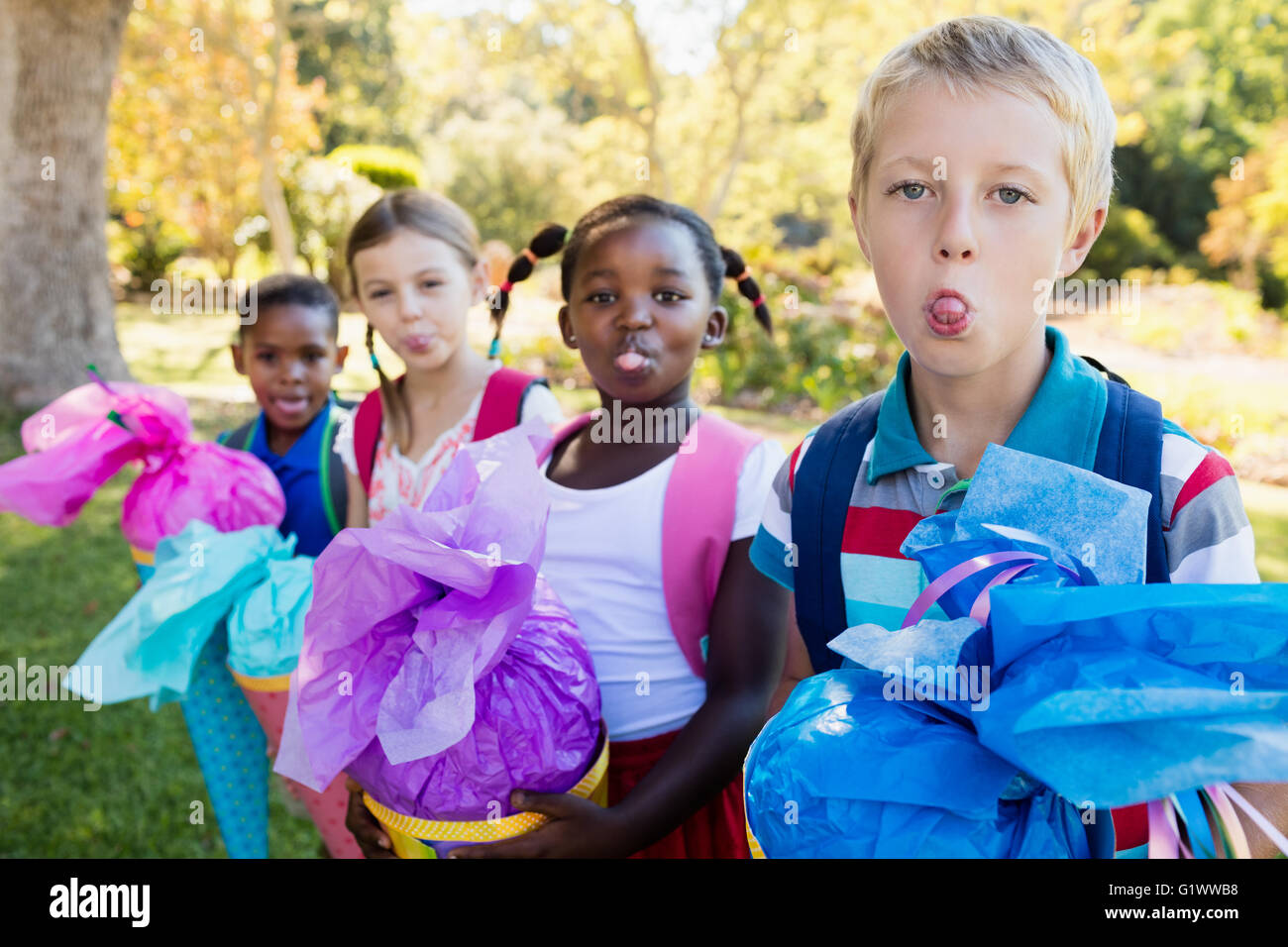 Kids are sticking their tongue out during a sunny day Stock Photo