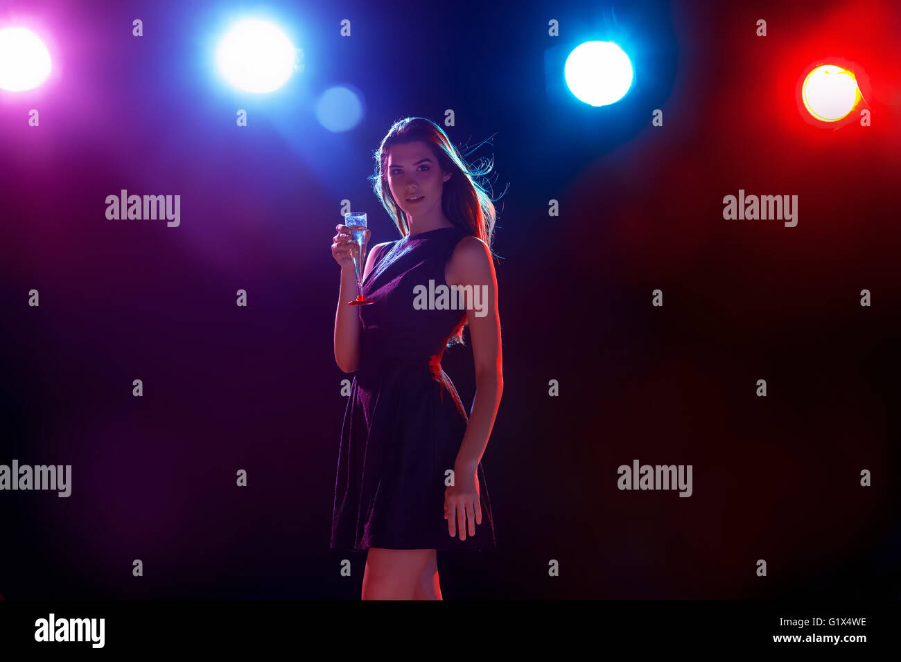 The beautiful girl dancing at the party drinking champagne Stock Photo ...