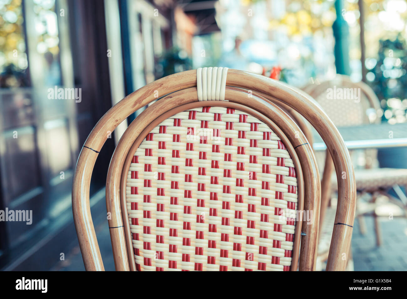 An empty chair outside a cafe in the street Stock Photo
