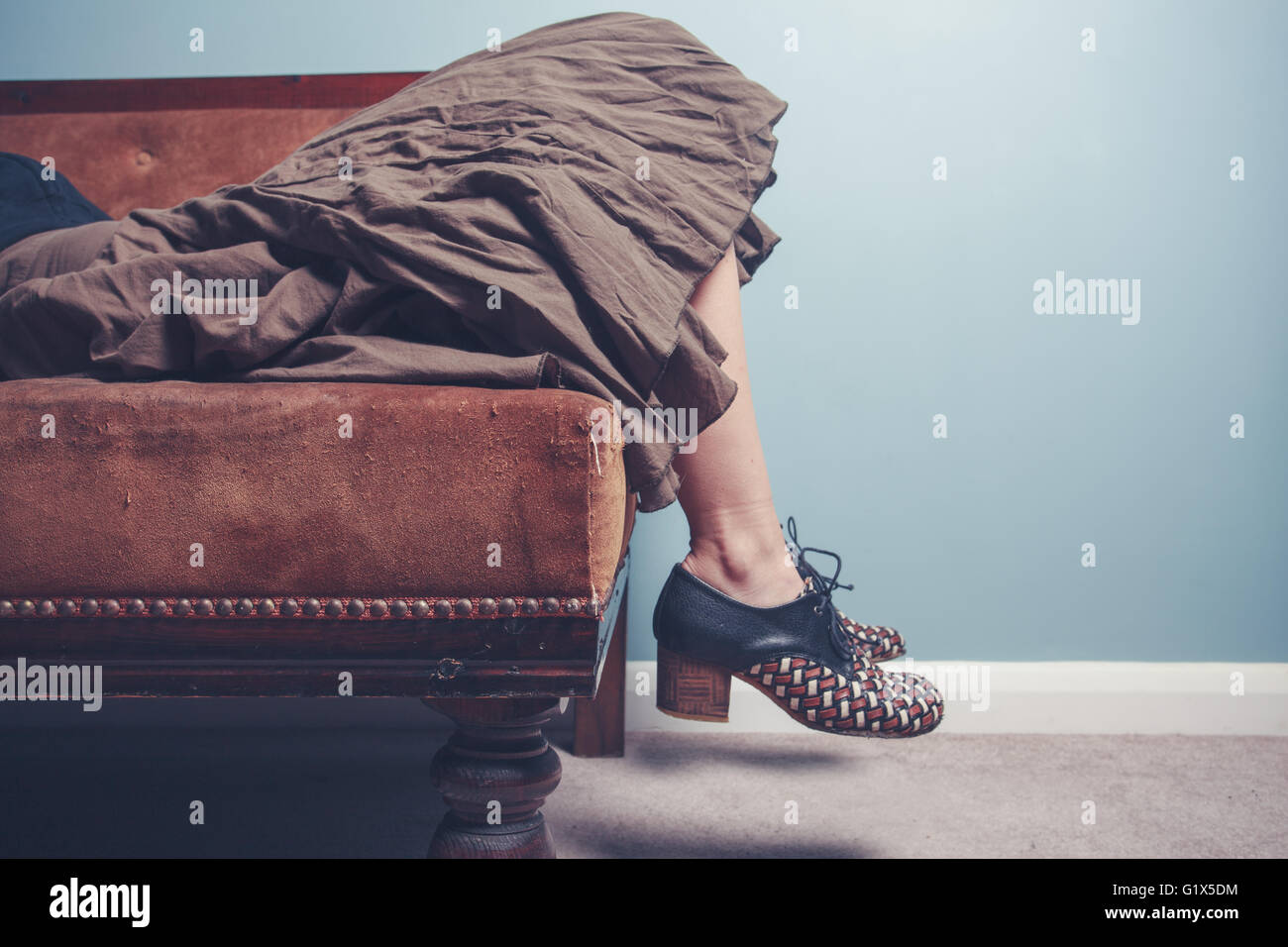 A woman with feet on a sofa hi-res stock photography and images - Alamy