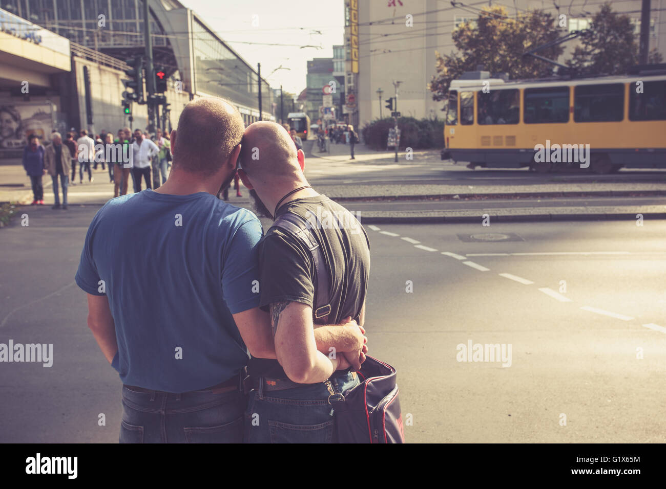 Homosexual couple waiting to cross the road in East Berlin on October 3, 2014 in Berlin, Germany Stock Photo