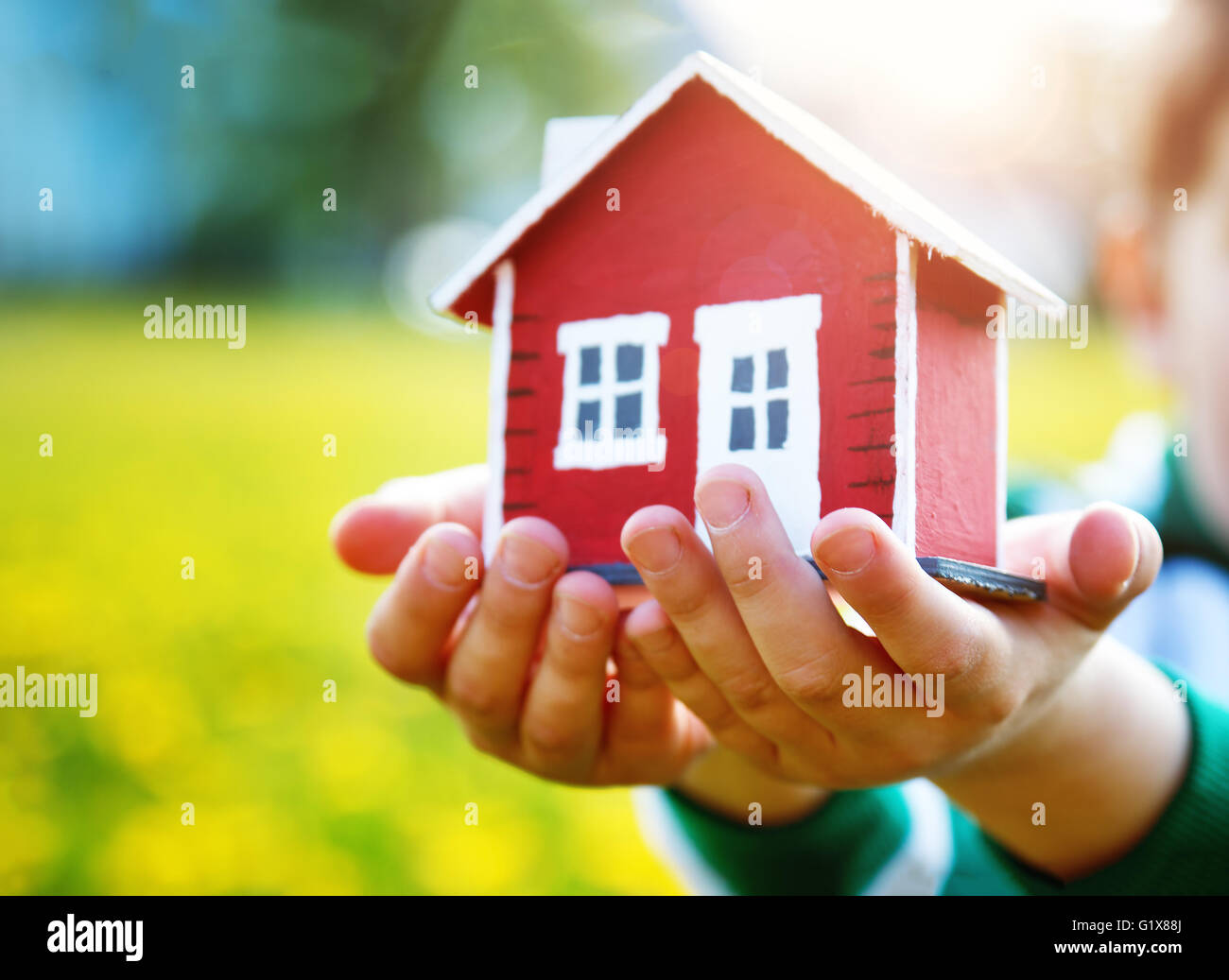 childs hands holding red model house Stock Photo - Alamy