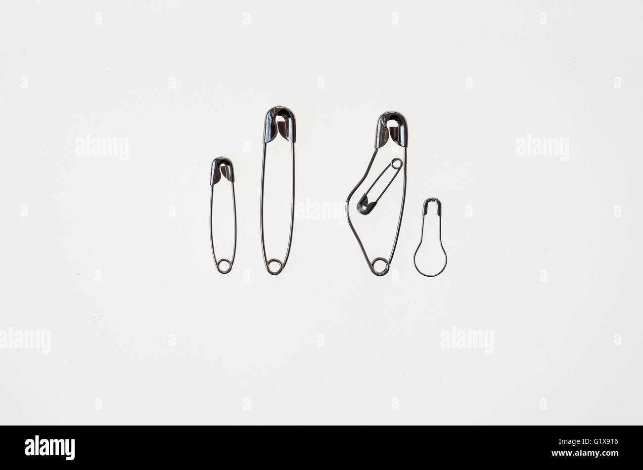 family composed by a pregnant safety pin a father and 2 sons Stock