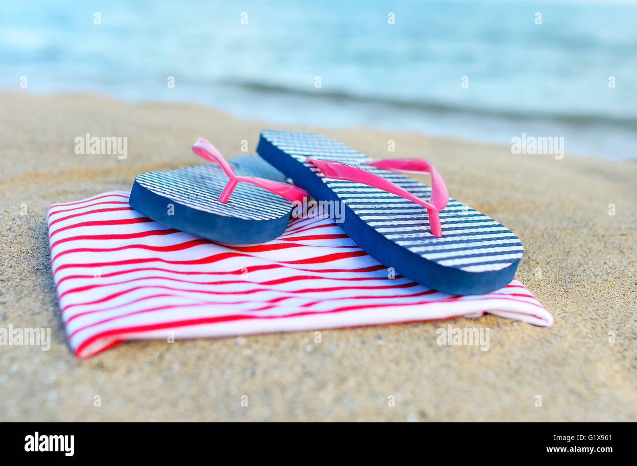 Things are scattered on the sea beach. Focus on glasses. Stock Photo