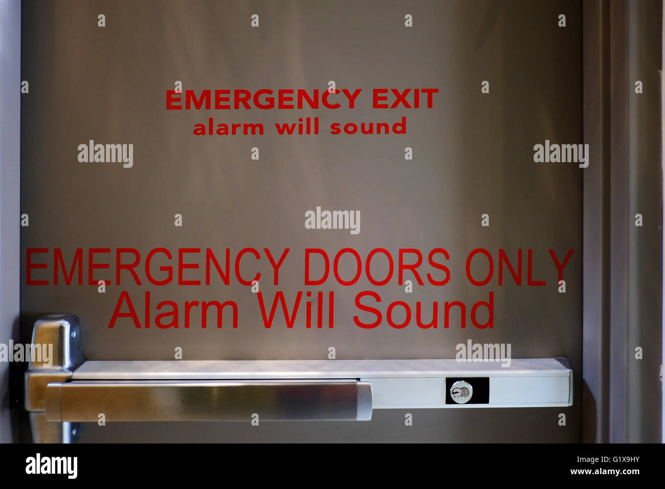 Inside of an emergency exit door reading "Emergency Exit Alarm Will