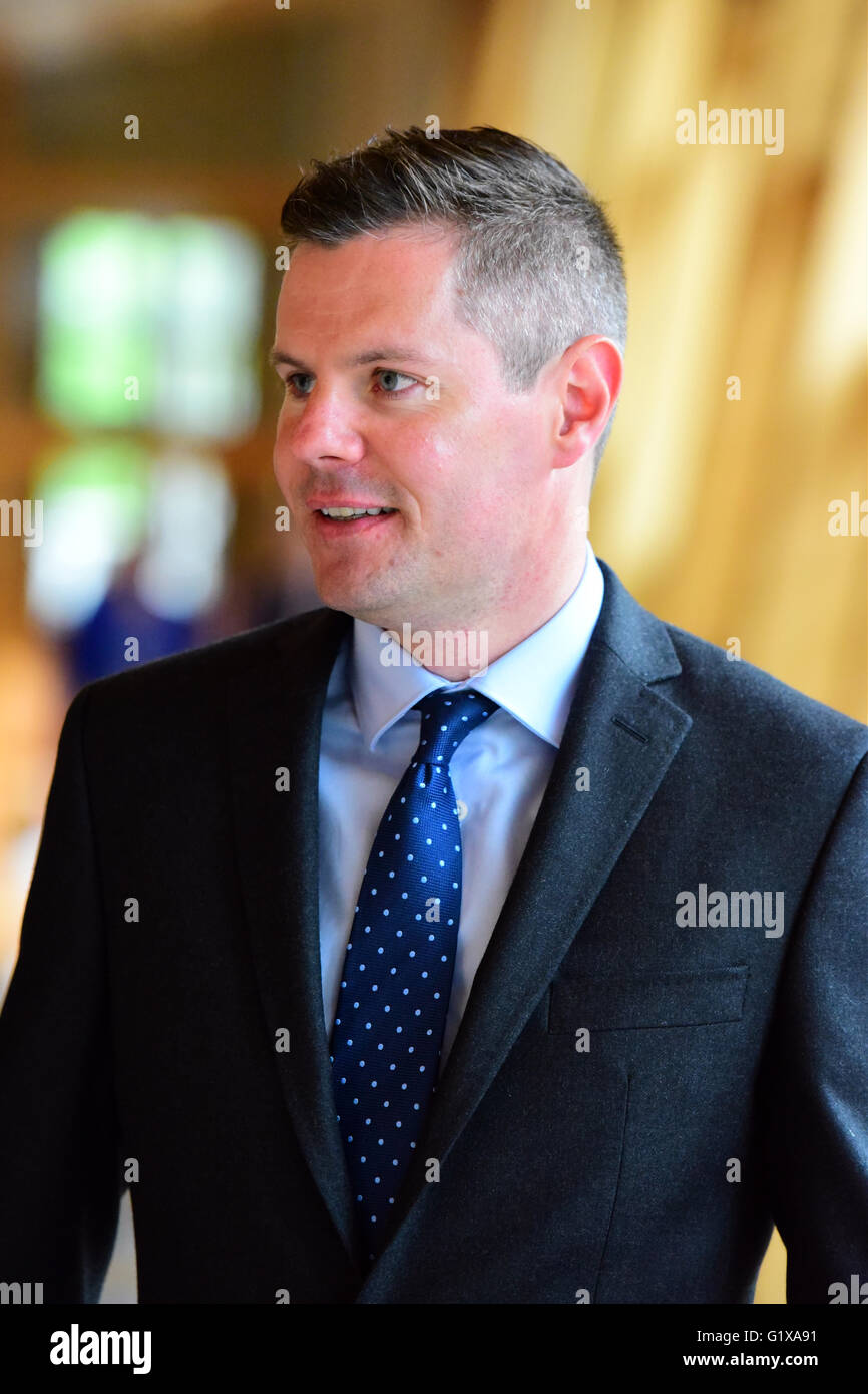 Newly-appointed Cabinet Secretary for Finance Derek Mackay makes his way to the chamber of the Scottish Parliament for the forma Stock Photo