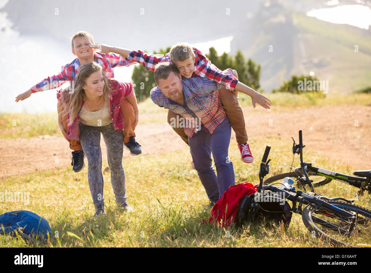 Family of four people with bikes in the mountains Stock Photo