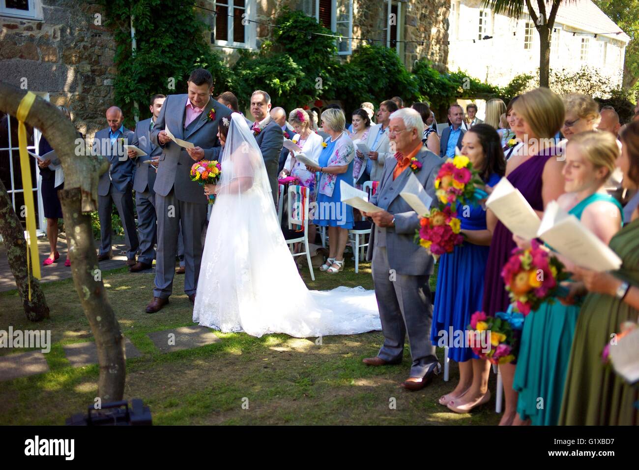 Bride and Groom singing along with family and guests at their outside