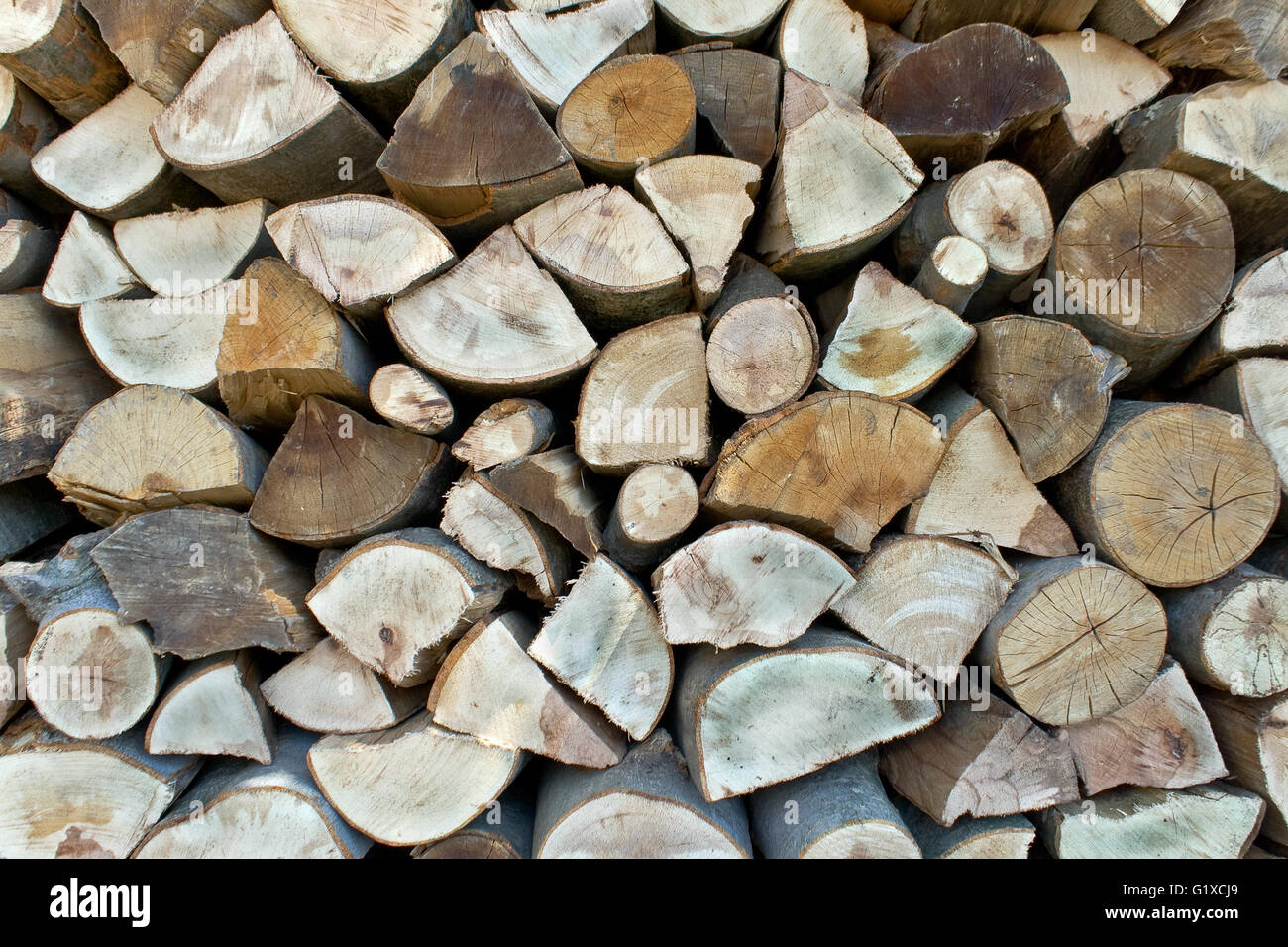 Chopped firewood logs in a pile as background Stock Photo - Alamy