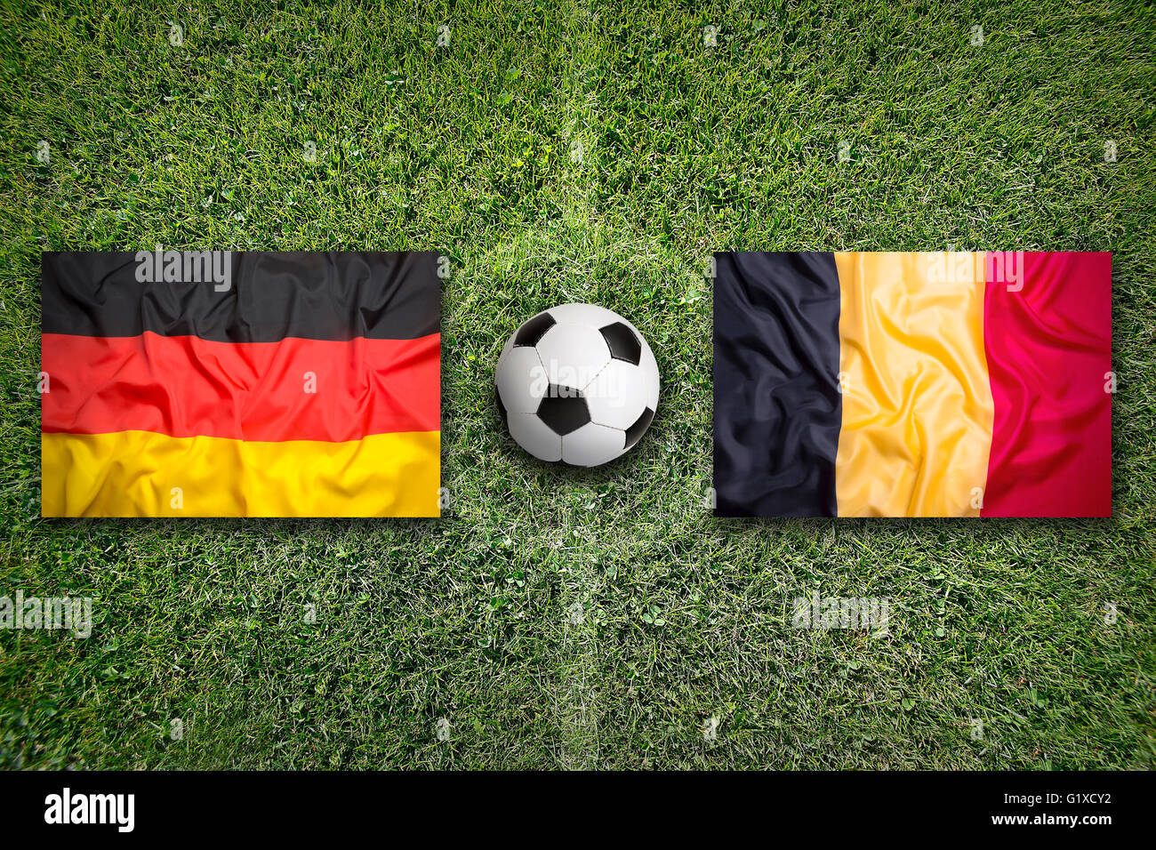 Germany vs. Belgium flags on a green soccer field Stock Photo - Alamy