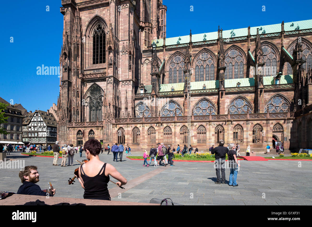 Female violonist, Place du Château square and Notre-Dame cathedral 14th century, Strasbourg, Alsace, France, Europe Stock Photo