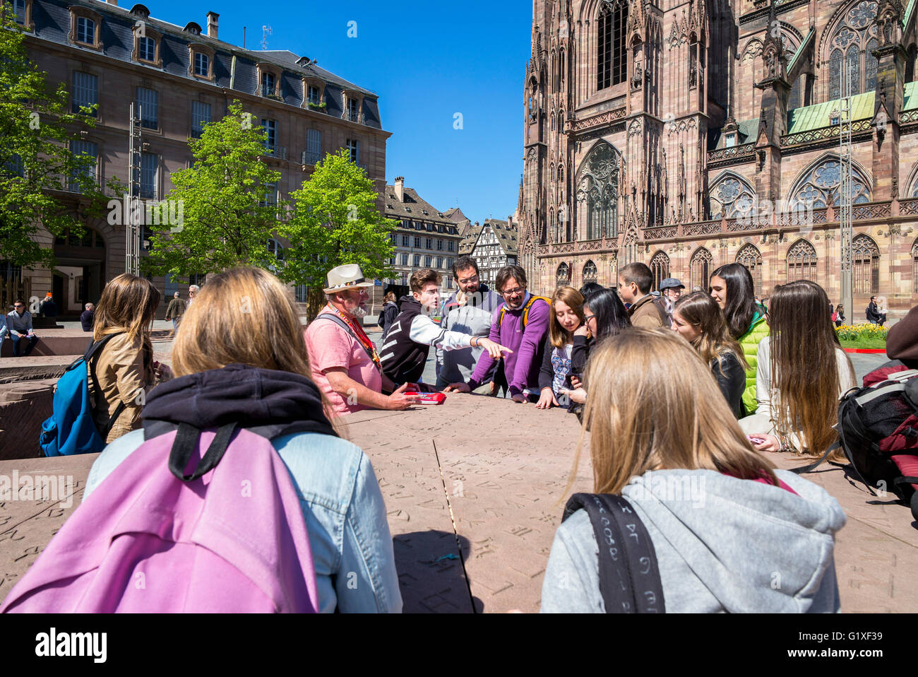 Teacher with students, Place du Château square and NotreDame gothic
