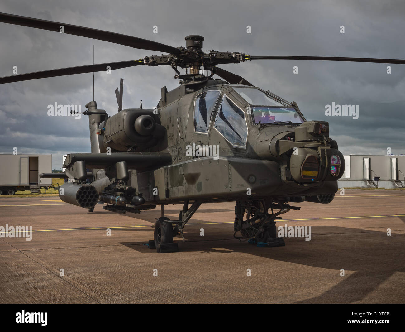Boeing AH-64 Apache helicopter at rest on airfield apron Stock Photo