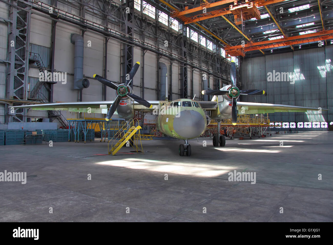 Kiev, Ukraine - August 3, 2011: Antonov An-32 cargo plane being final assembled at the aircraft manufacturing hangar Stock Photo