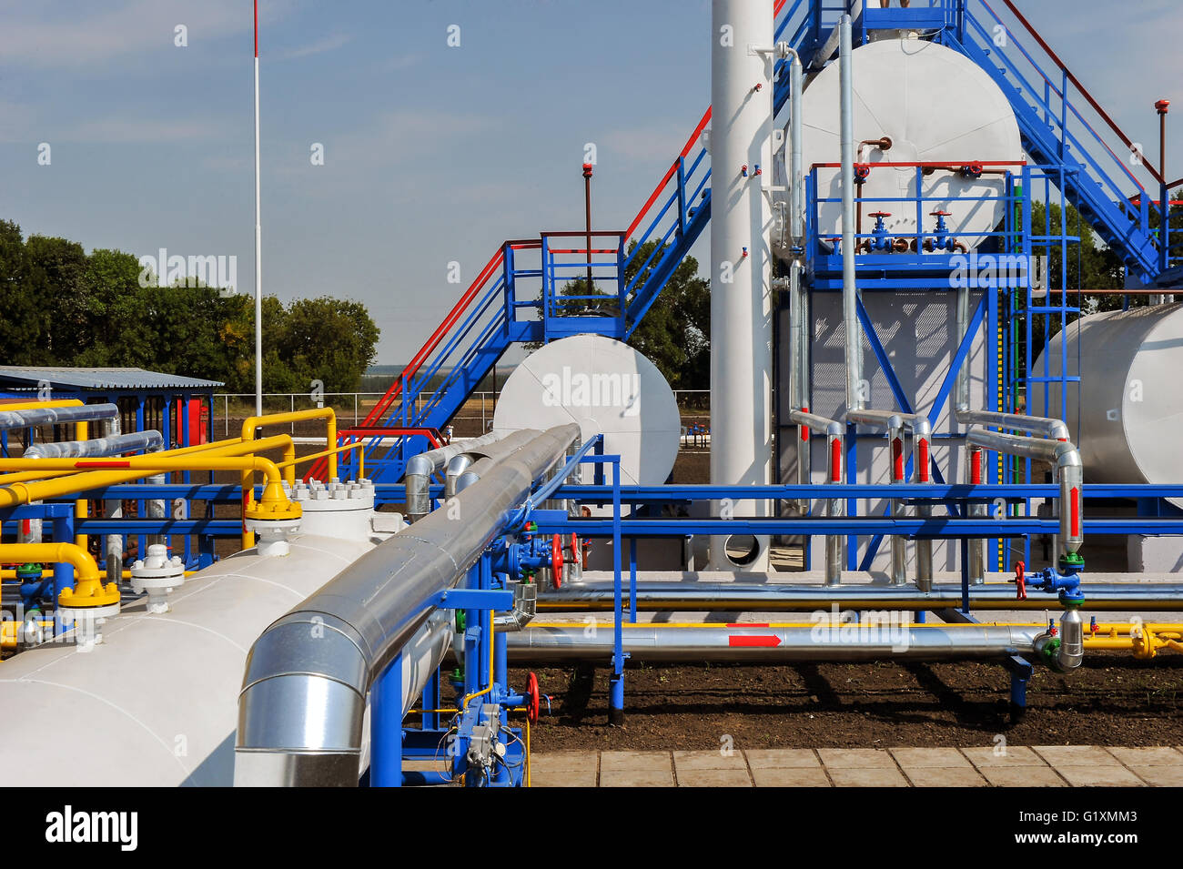 White fuel tanks and color gas pipes in natural gas treatment plant in