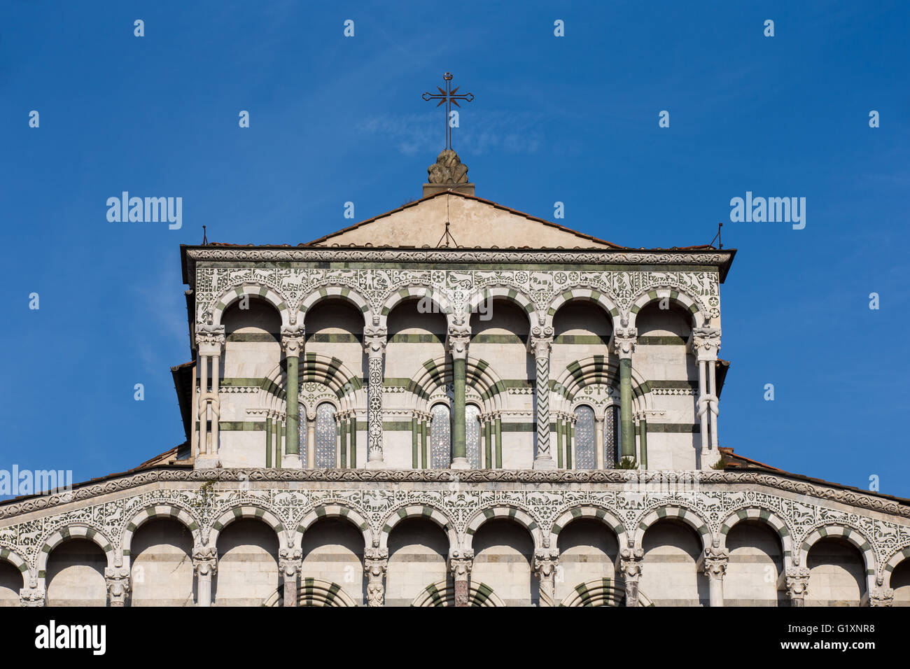 Ornate upper marble facade of the Cathedral of San Martino in the Tuscan village of Lucca, Italy showing ornate architecture. Stock Photo