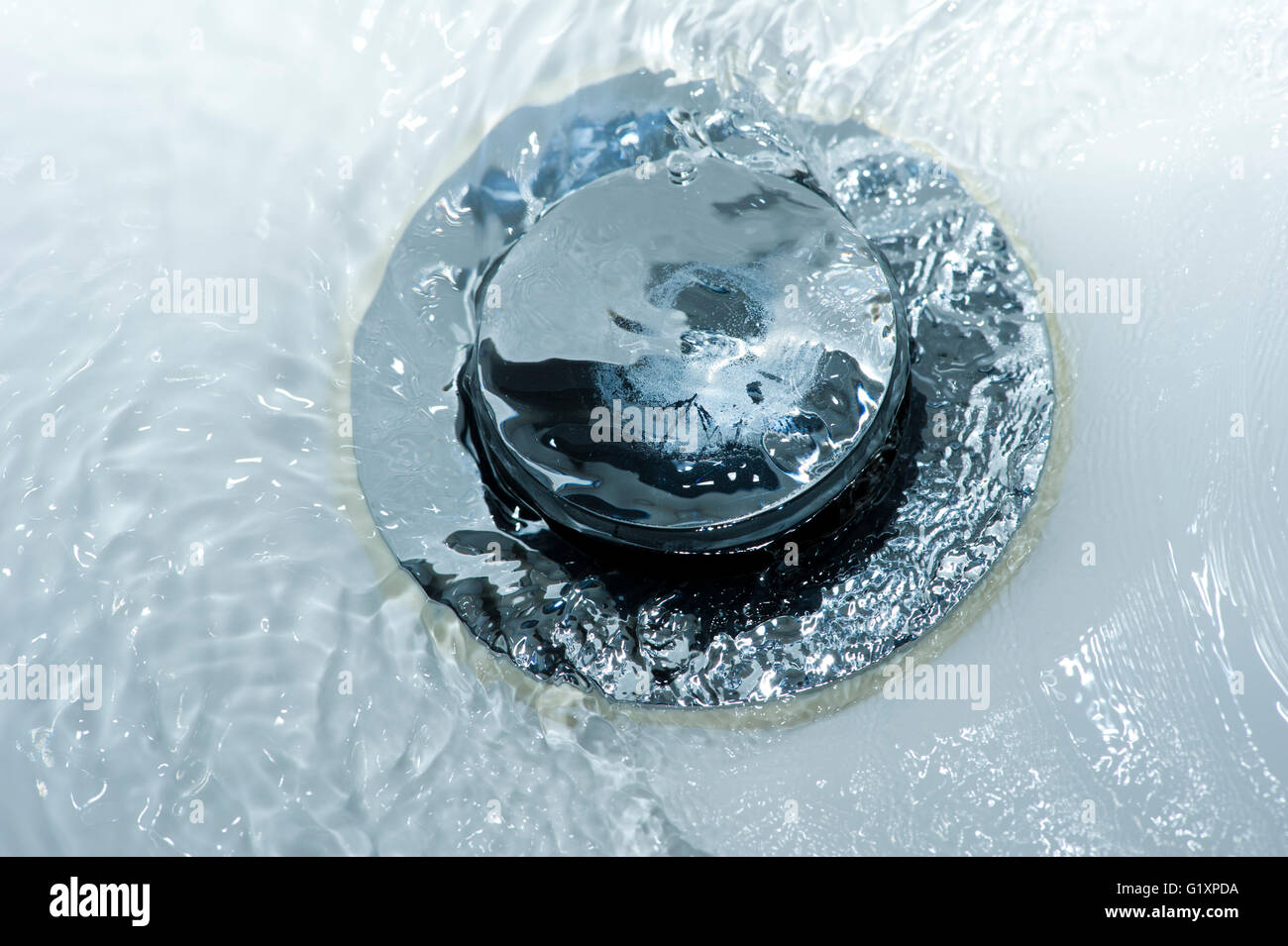 Water pouring down a sink plughole Stock Photo Alamy