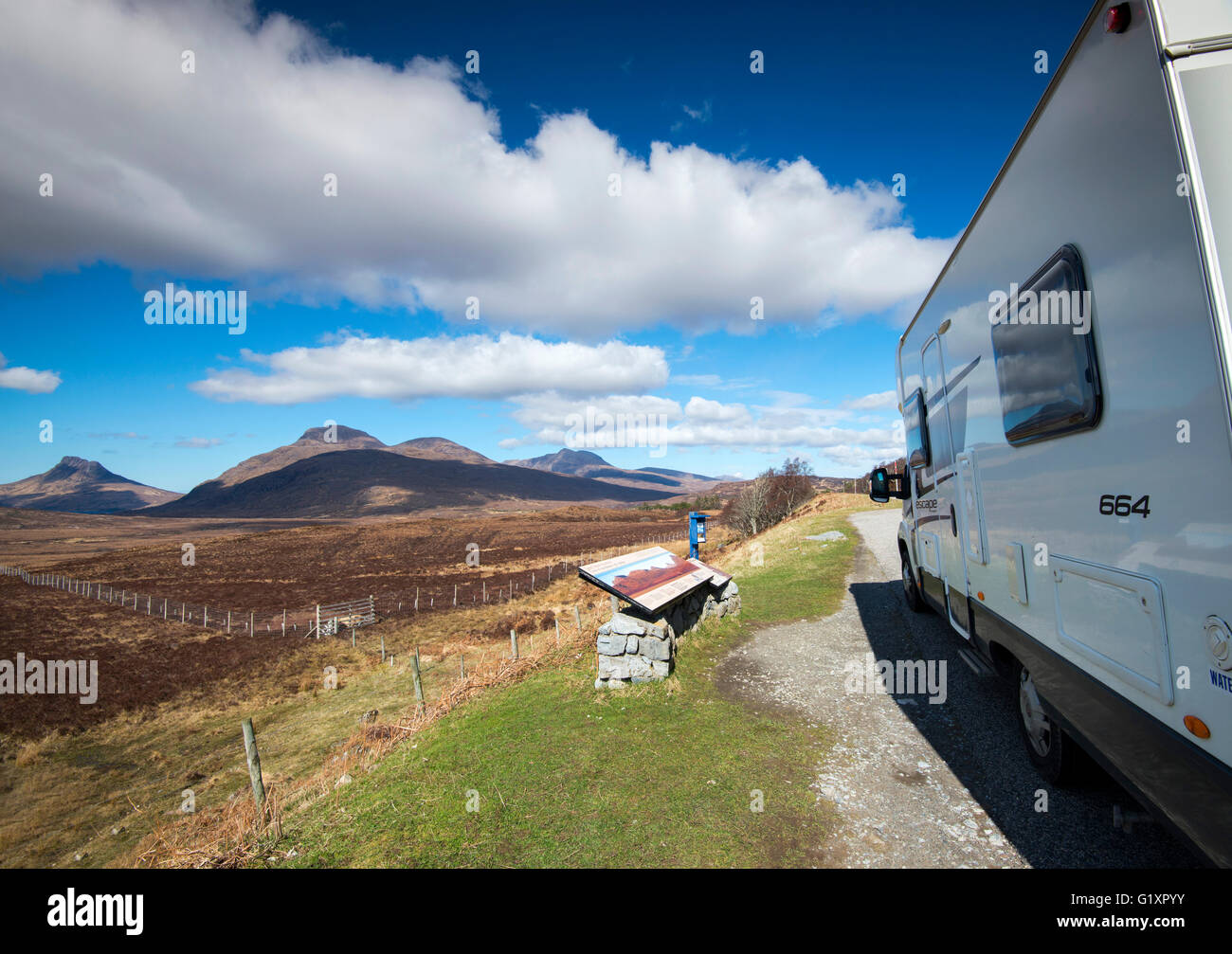 Motorhome parked up at a viewpoint on the A835, by the Deep Freeze Mountain Range, in Sutherland Scotland UK Stock Photo