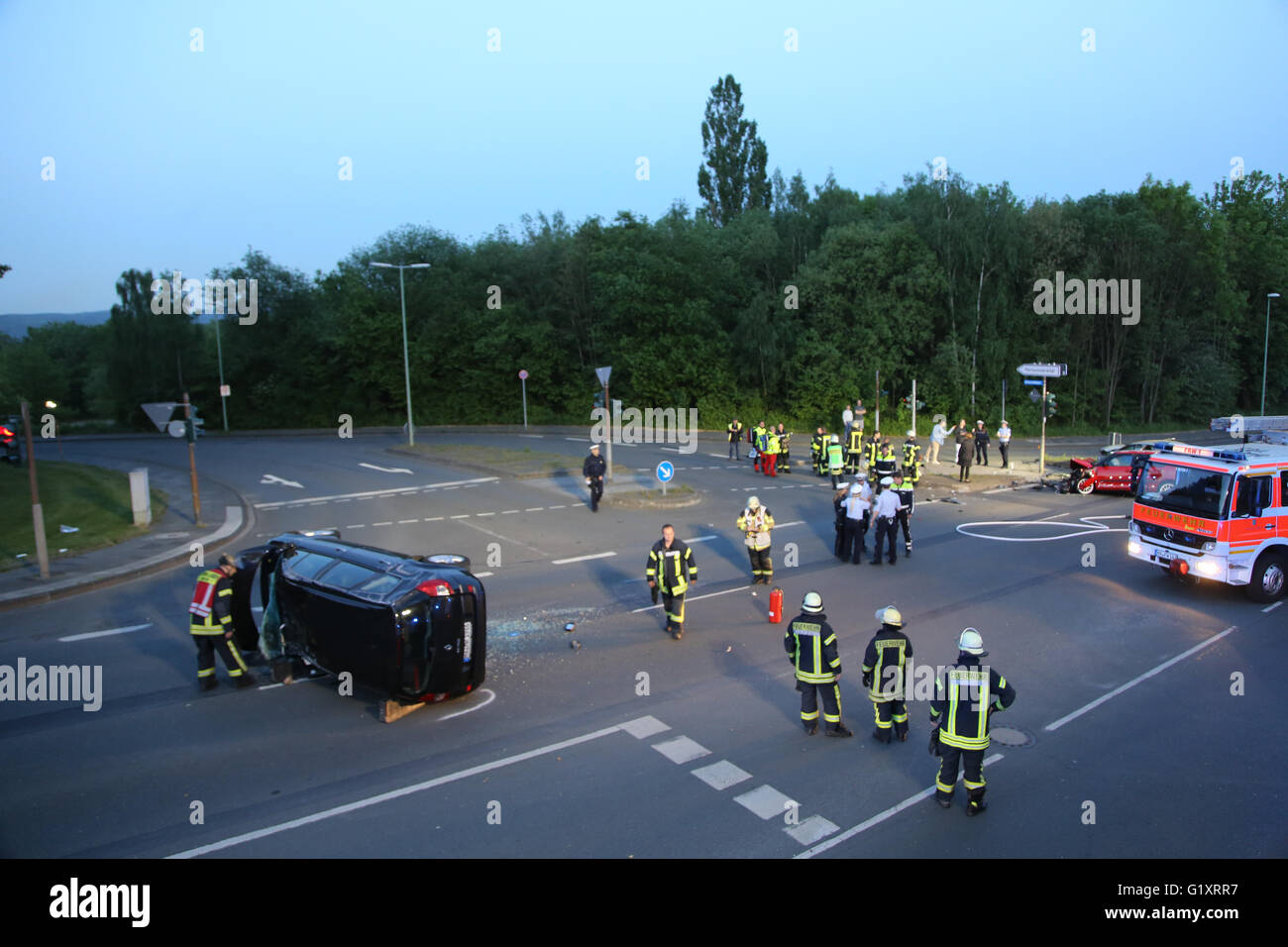 Hagen, Germany. 19th May, 2016. Rescuers examine a car after a crash at