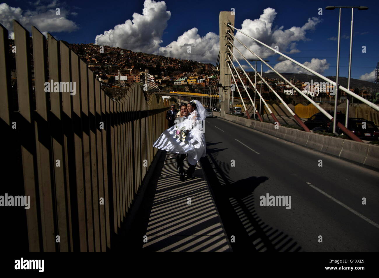 Apr 16, 2016 - La Paz, Bolivia - Weddings in the triple bridges. In La Paz, Bolivia, marriage is still considered as the economical alliance between families in the old spanish way. La Paz and El Alto most of them indigenous families get the wedding business as a very serious thing. One of the principal step for just married is going through one, two or three of the recent built continuous three bridges going from west to east canyons of the accident city. It's a way to seal a kind of pact between families and symbolically pass from a celibate life to married one. Get some champagne' (cheap ci Stock Photo