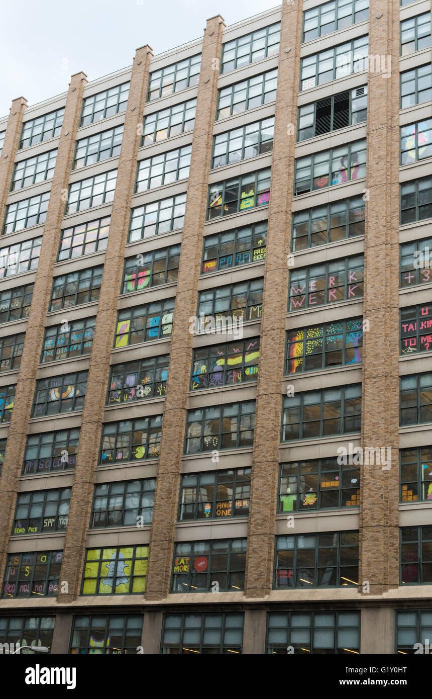 Colourful pixel art made from Post-It notes by employees in the windows of rival office buildings on Canal Street, New York City Stock Photo
