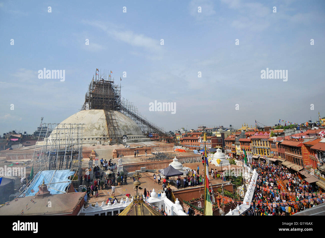 Devotees offering rituals prayer at the Boudhanath stupa, one of the largest stupas in the world during celebration the 2,560th Buddha Purnima festival, Birth Anniversary of Lord Gautam Buddha at Boudhanath Stupa, Kathmandu on May 21, 2016. Buddhists around the world, Cambodia; Thailand; Myanmar; Bhutan; Sri Lanka; Laos; Mongolia; Japan; Singapore; Taiwan including Nepal, observe Buddha Purnima festival which falls on the same day of full moon of the month calendar. The occasion offerings of flower, incense and candles, an exchange of gifts as blessings, prayers, sermons and group meditations. Stock Photo