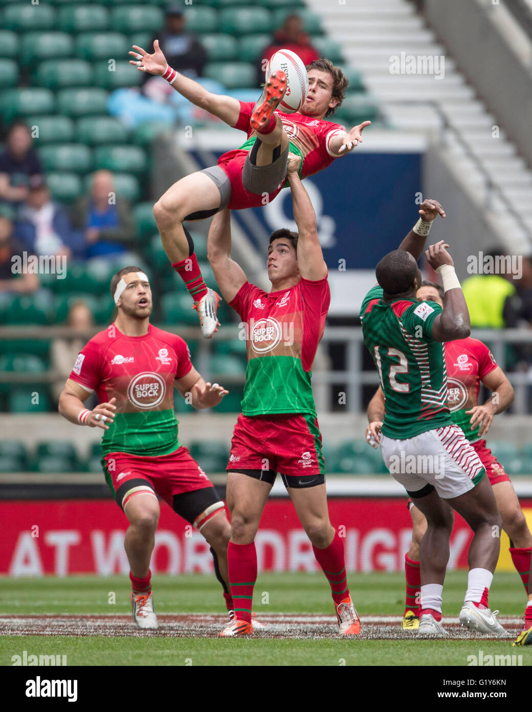 London, UK. 21st May, 2016. ESTEVES Aderito is lifting GUEDES Nuno (both Portugal). Right side: AMBAKA Willy (Kenya, 12) during the Rugby Tournament game of Portugal vs. Kenya in London, England, 21 May 2016. Photo: Juergen Kessler/dpa - NO WIRE SERVICE-/dpa/Alamy Live News Stock Photo