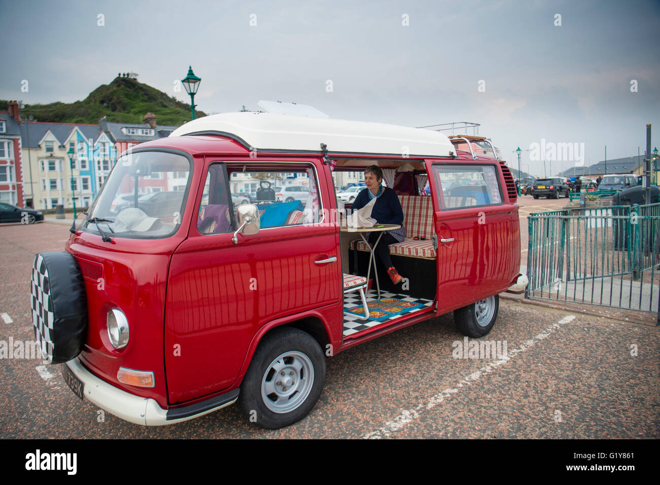 A woman sitting inside her classic red 1972 Volkswagen VW T2 (type 2)  camper van, on the seafront in Aberdyfi, Snowdonia National Park, Wales UK  Stock Photo - Alamy