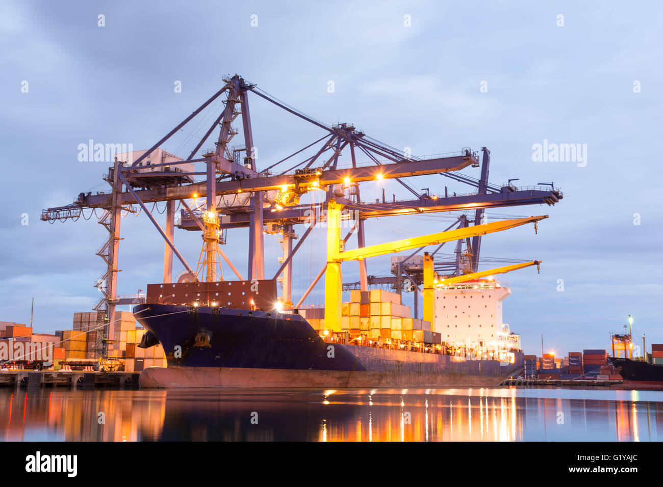 Container ship in the harbor of LeamChabang, night shot. Cloudy sky. Stock Photo