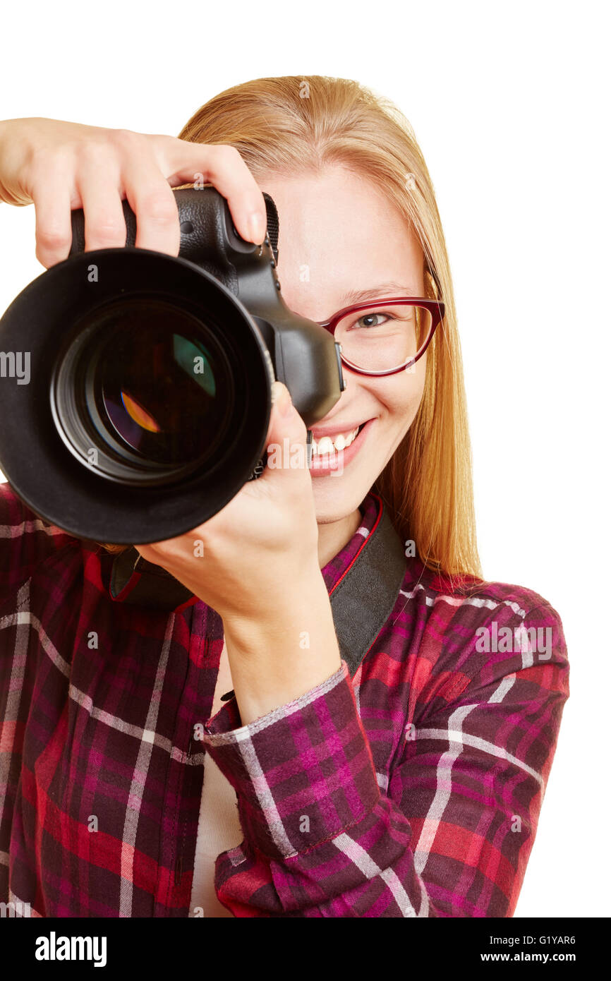 Smiling young woman with digital camera as photographer Stock Photo