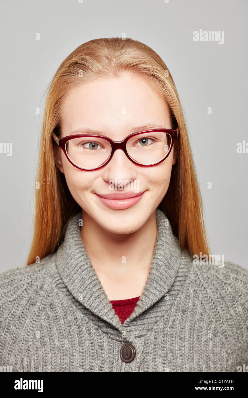 Head shot of a young blond woman wearing glasses for a job application Stock Photo