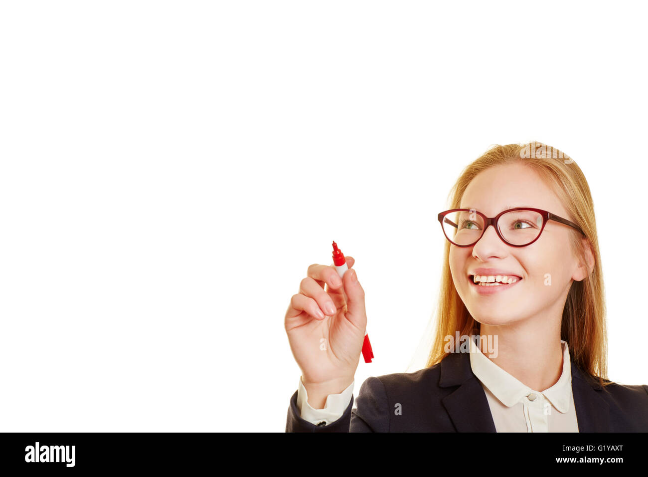 Blond smiling businesswoman writing with a red pen Stock Photo