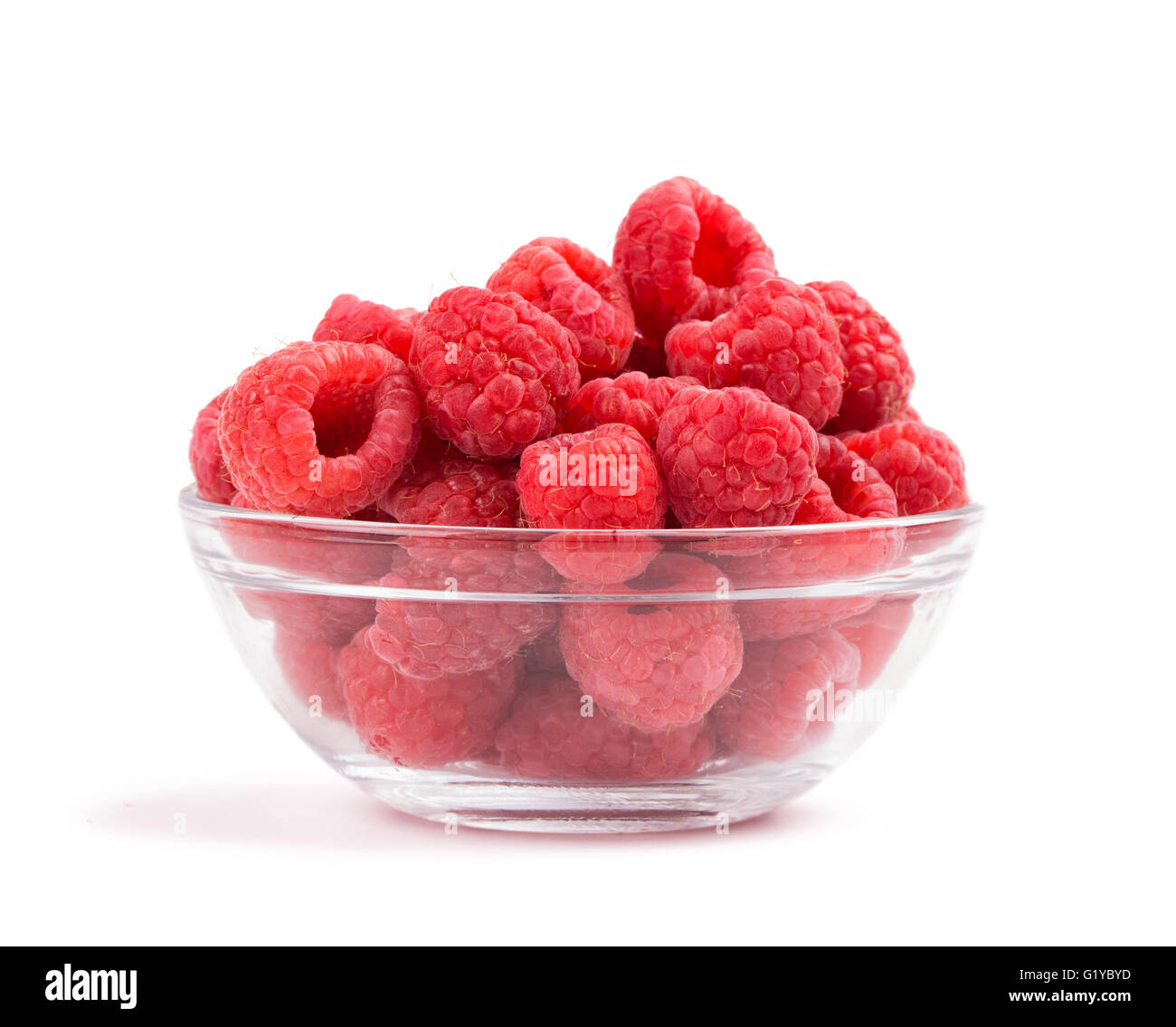 Raspberries in a glass bowl, on white Stock Photo