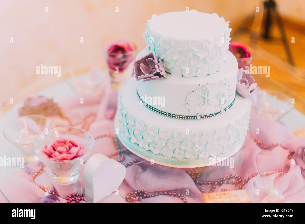 Blue and white wedding cake decorated with violet flowers Stock Photo