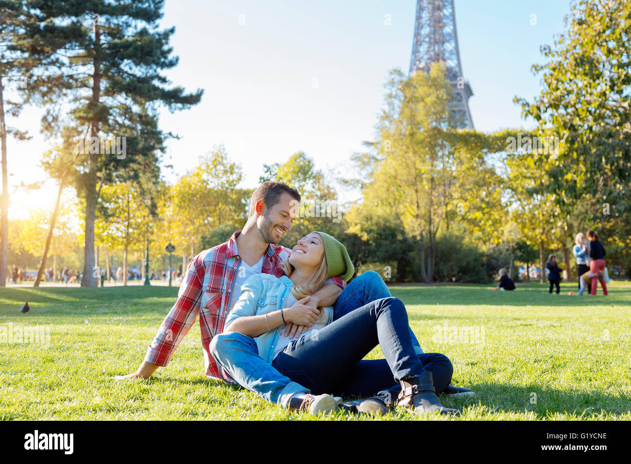 Young couple with arms around each other hi-res stock photography and ...