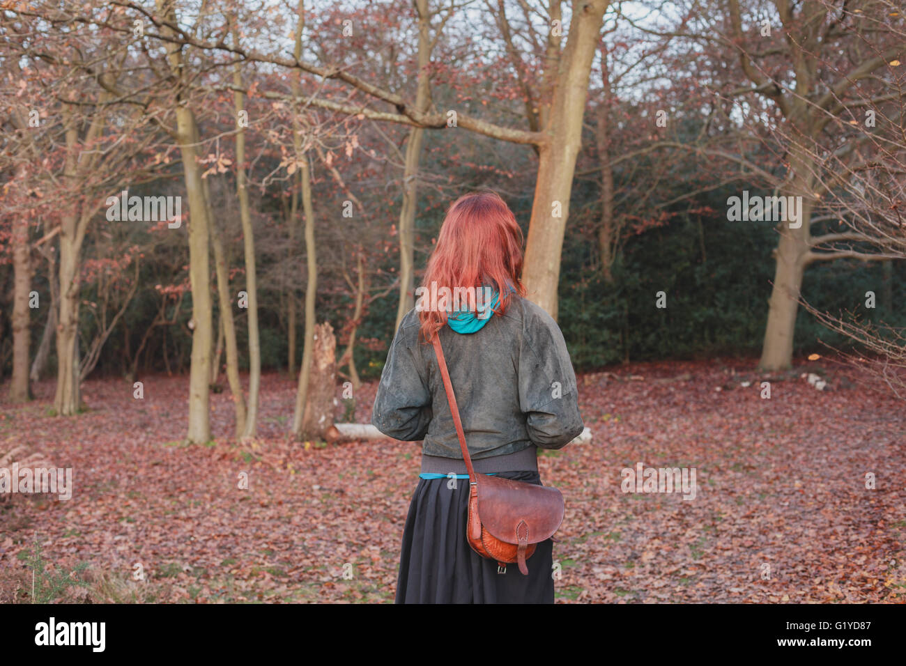 A young woman is standing in the forest in autumn Stock Photo - Alamy