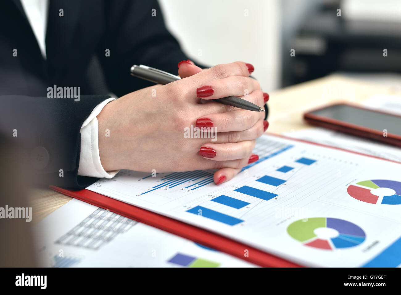 accountant woman siting in office with start up report on table Stock Photo