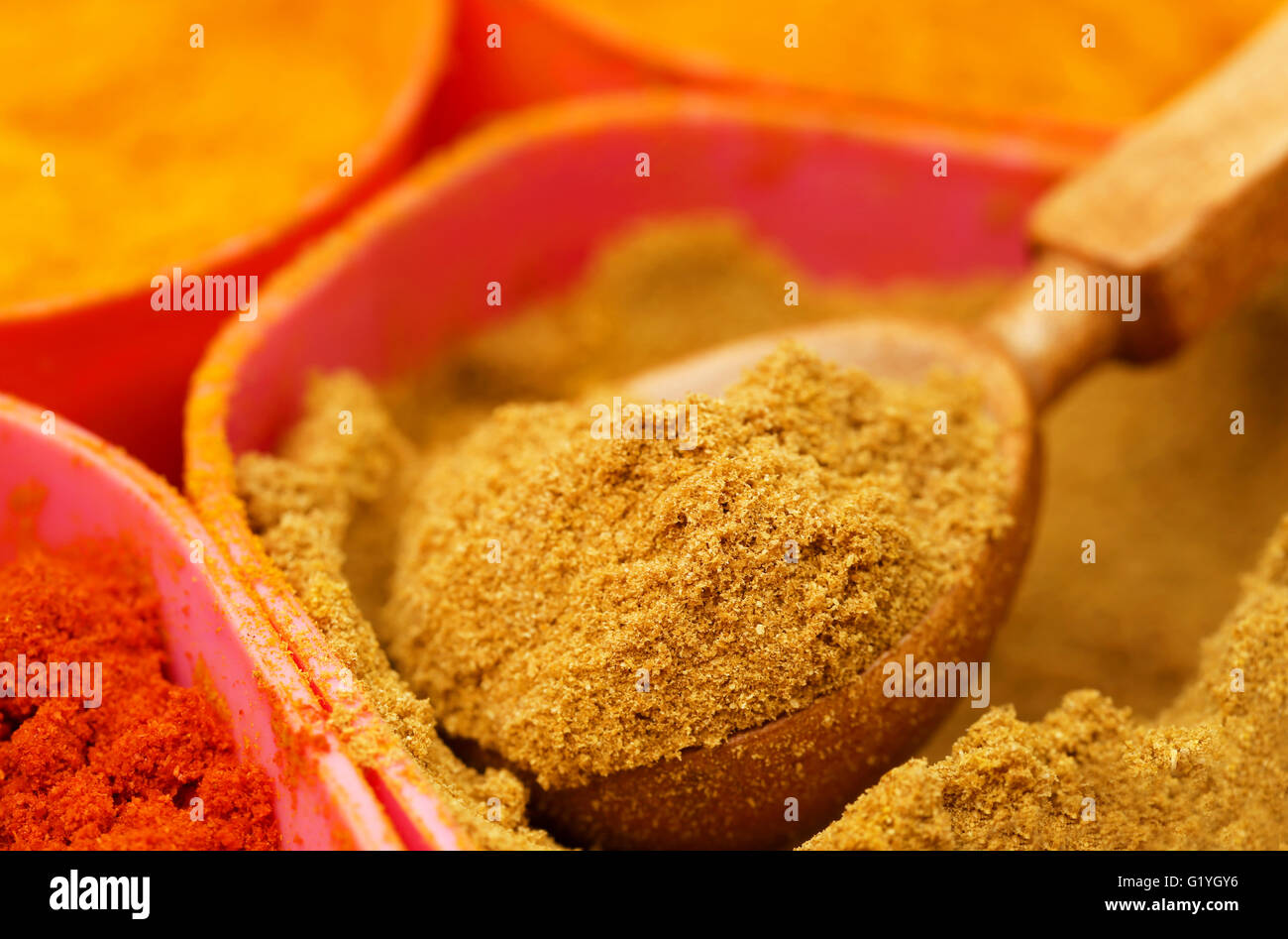 Ground coriander with other spices in container Stock Photo Alamy