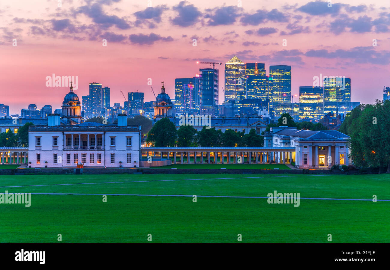 View of Queens House and Canary Wharf from Greenwich Park, London with a sunset sky Stock Photo