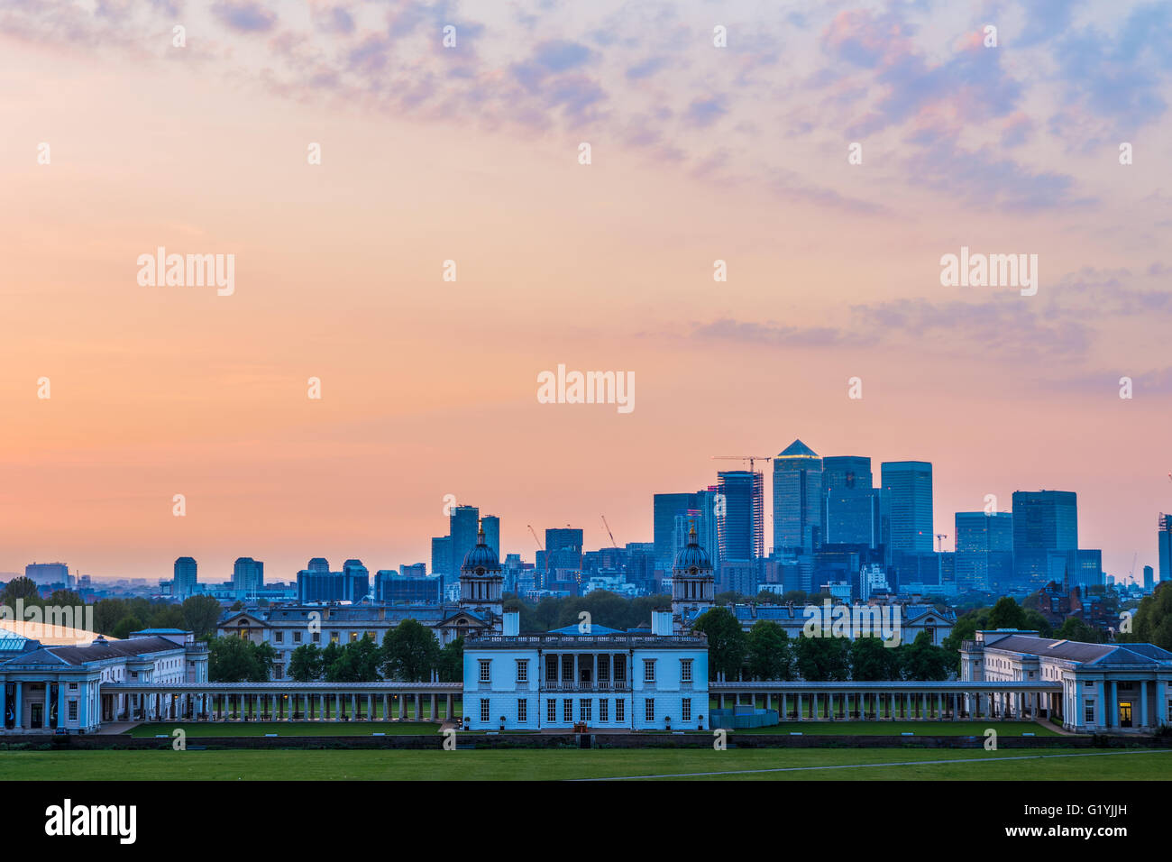 View of Queens House and Canary Wharf from Greenwich Park, London with a sunset sky Stock Photo