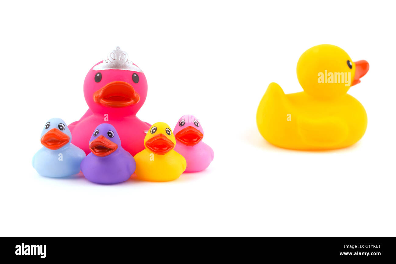 Mother rubber duck with children, with father leaving the group - concept of separation or divorce - on white Stock Photo