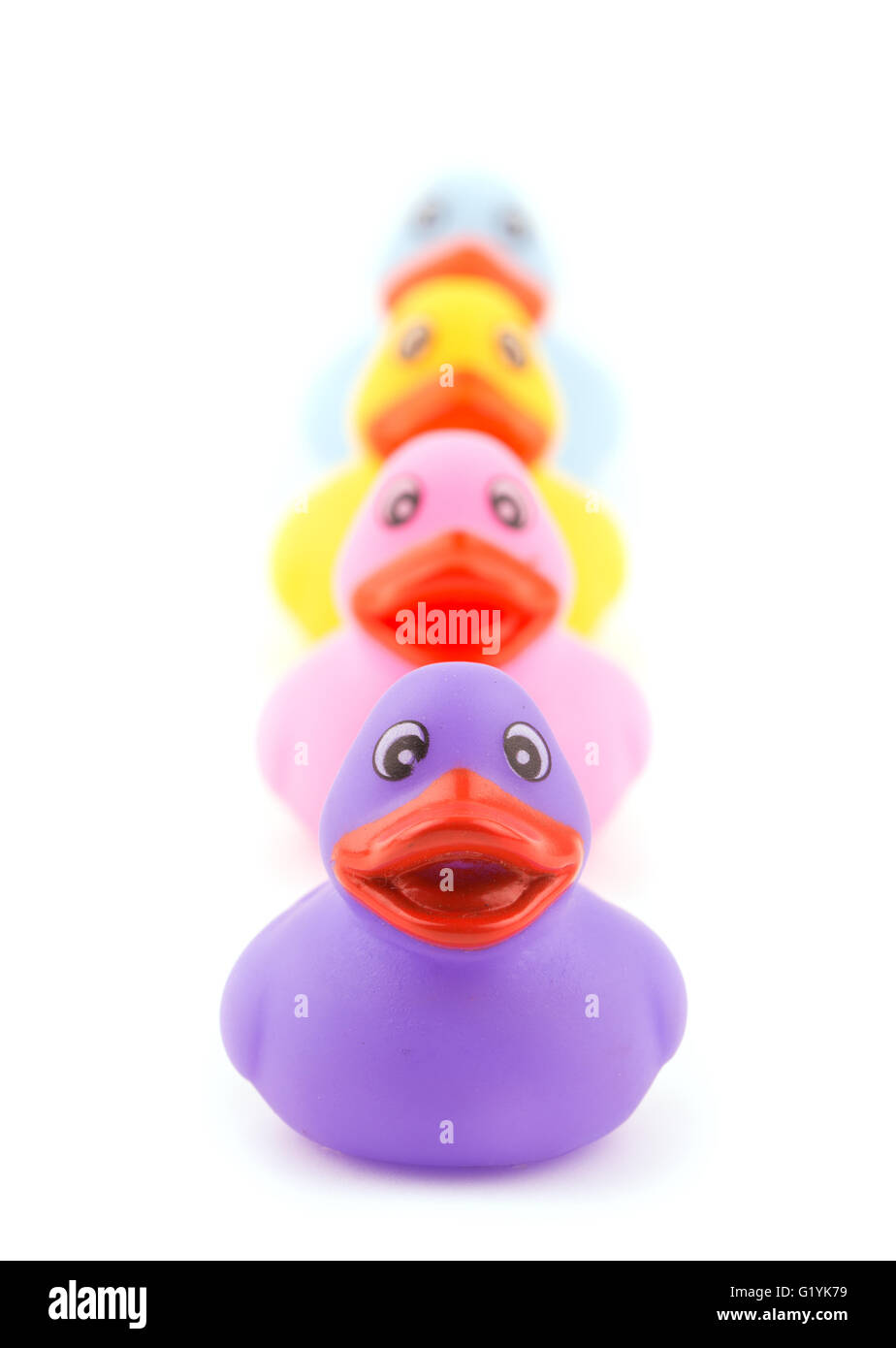 Line of colorful rubber ducklings, on white Stock Photo