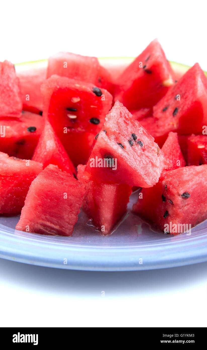 Vertical closeup of watermelon chunks on a blue plate Stock Photo