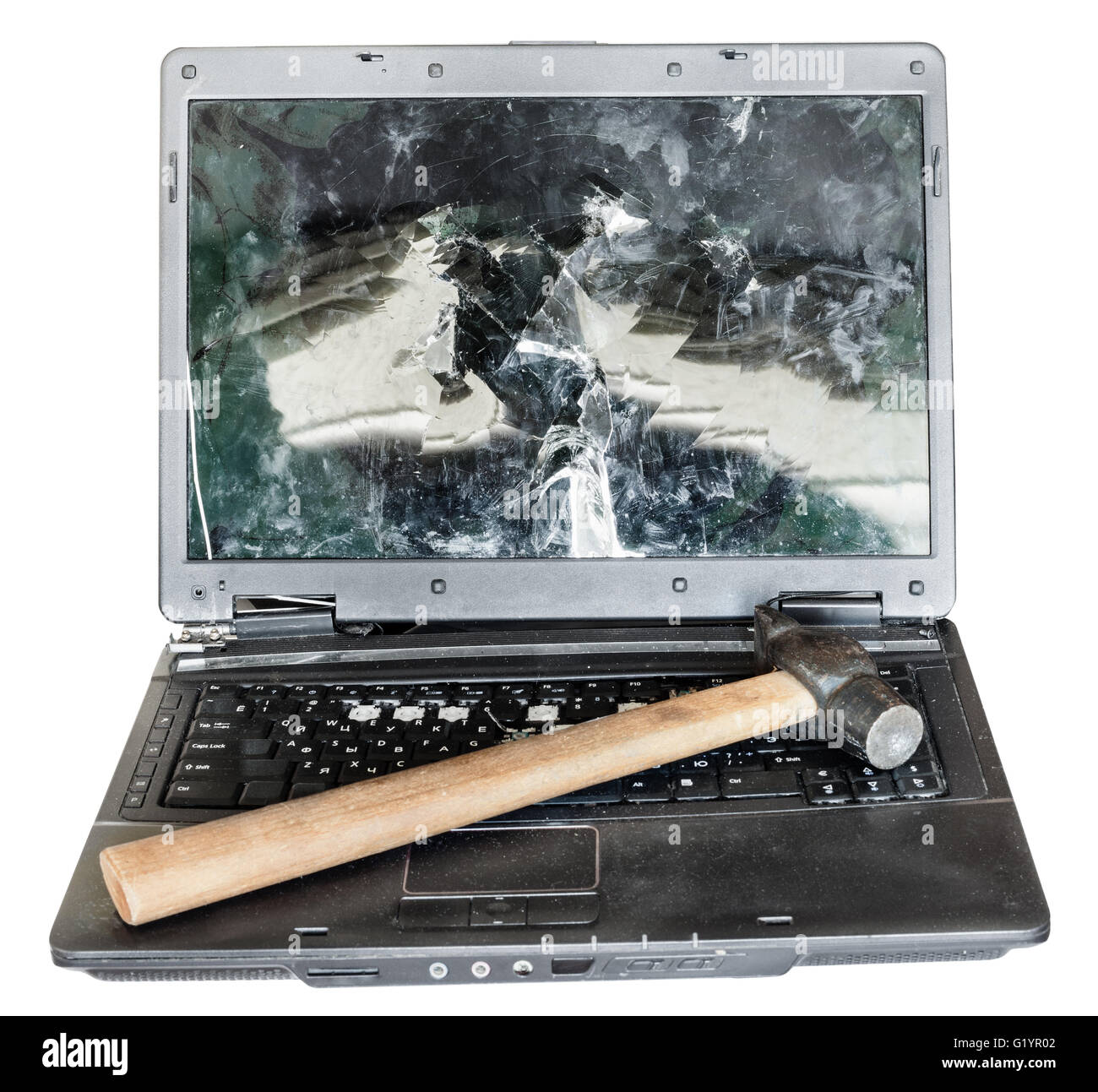 direct view of old broken laptop with hammer on keyboard isolated on white background Stock Photo